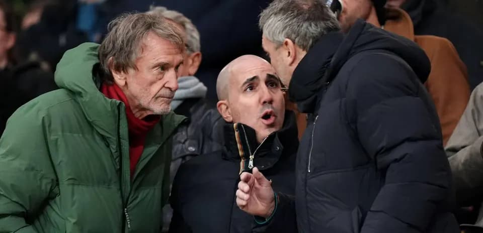 Three spectators engaged in conversation at match
