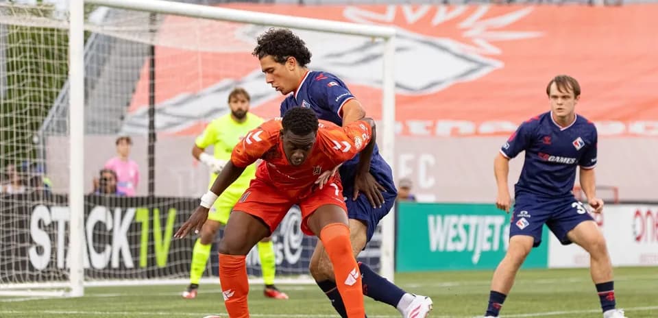 Players contesting possession during CPL match