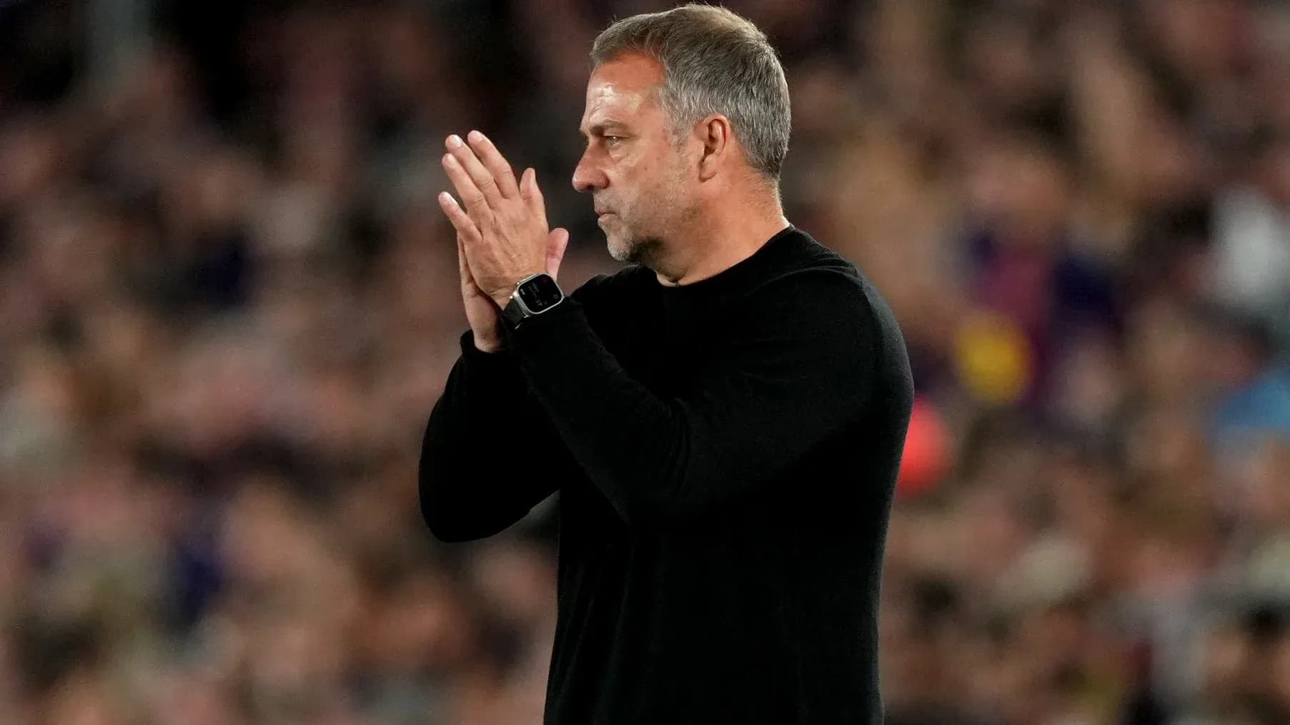Coach applauding during a match on the sidelines