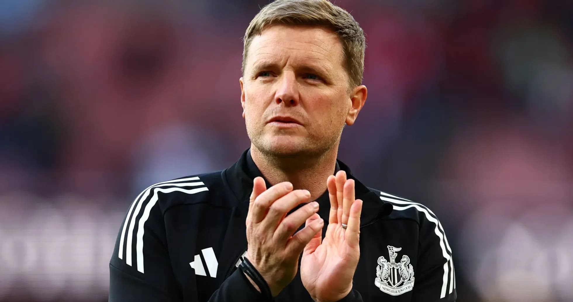 Manager applauding during match at stadium