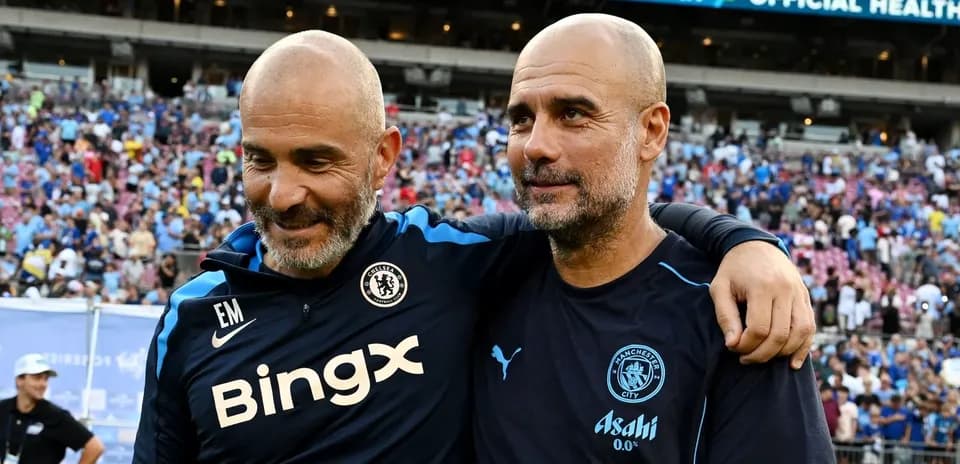 Two coaches embracing after a football match