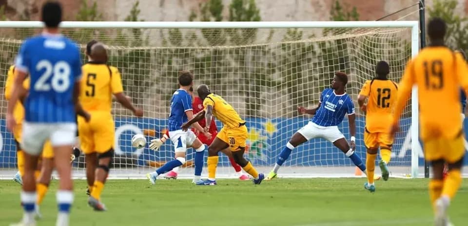 Players in action during a soccer match near goal