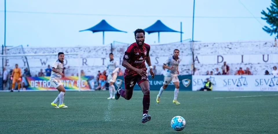 Detroit City player running with the ball