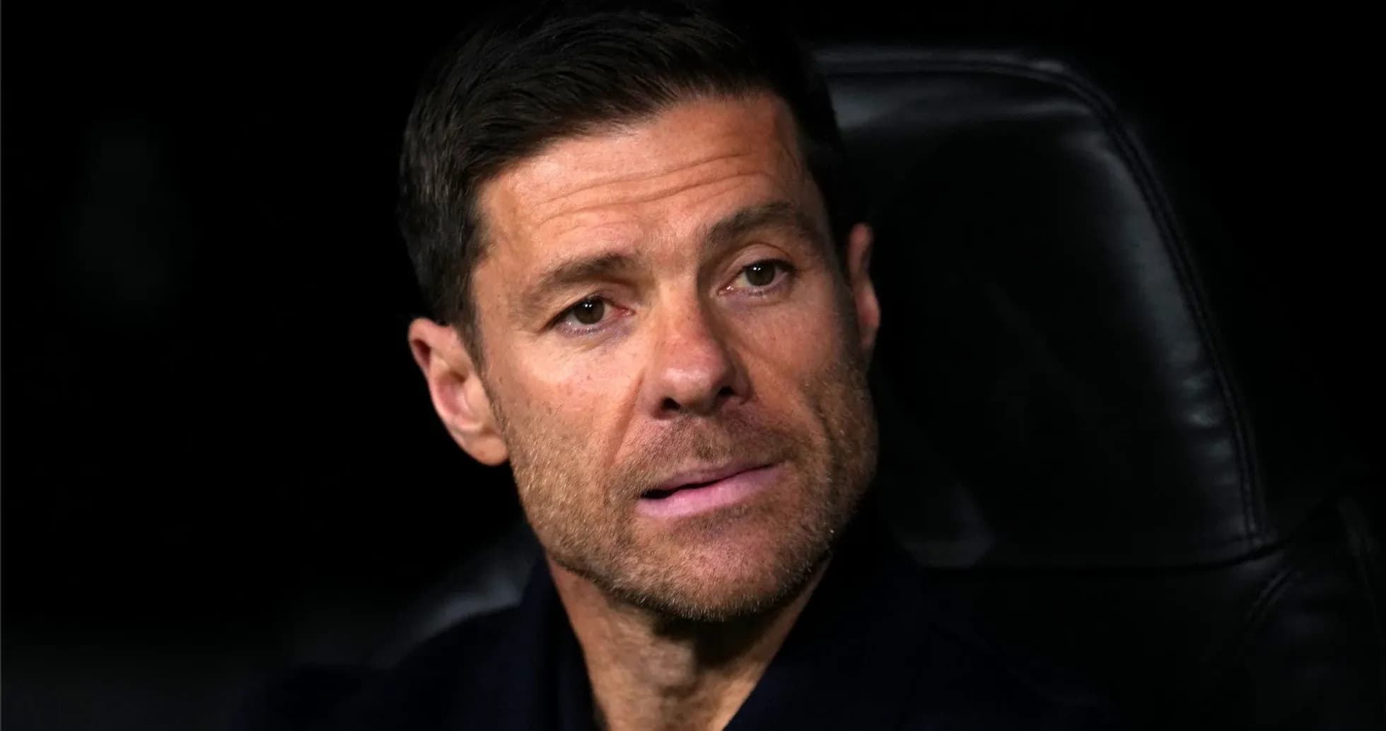 Coach sitting on bench during match