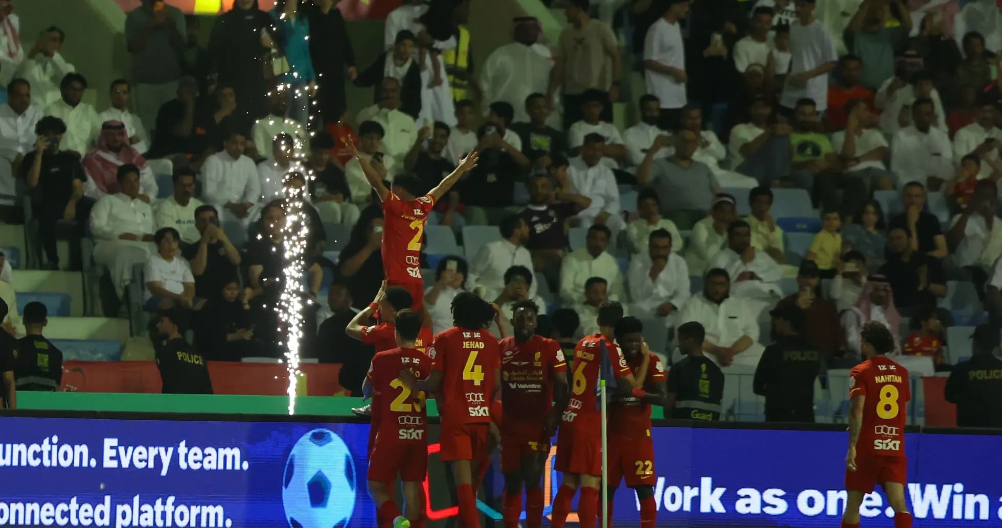 Celebrating players with fireworks during a match