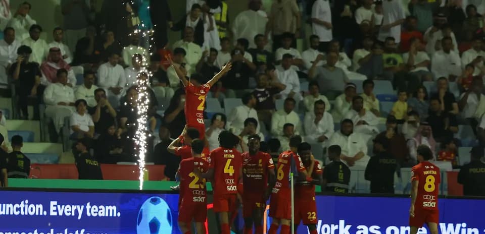 Celebrating players with fireworks during a match
