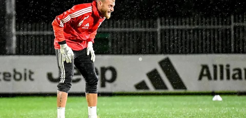 Goalkeeper training in rain at outdoor pitch
