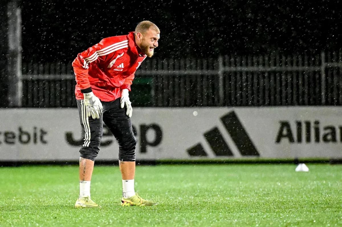 Goalkeeper training in rain at outdoor pitch