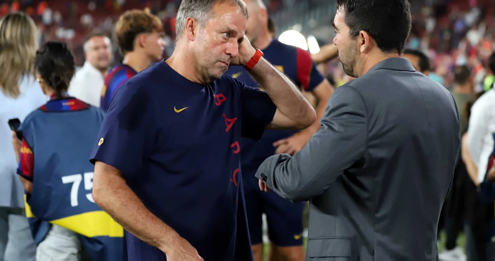 Two coaches discussing on the sidelines after match