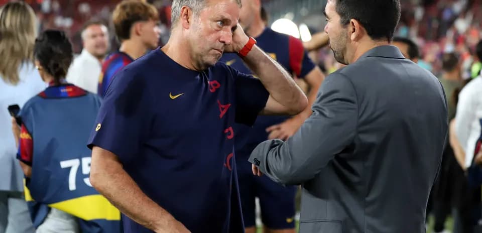 Two coaches discussing on the sidelines after match