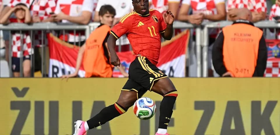 Belgian player sprinting with ball during match