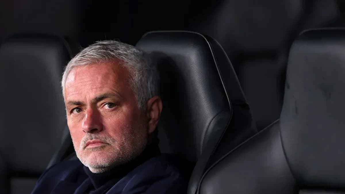 Manager seated on bench during a match
