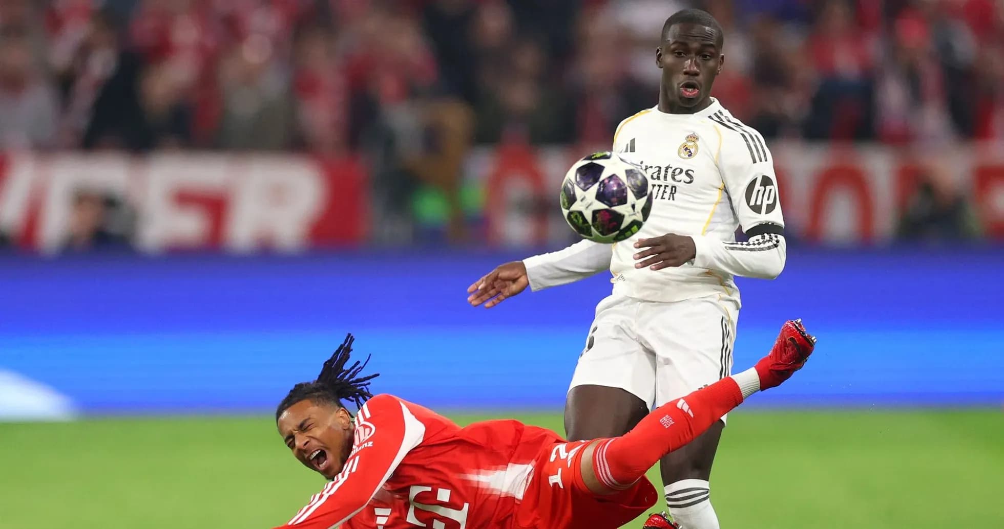 Player falling as opponent attempts to control ball