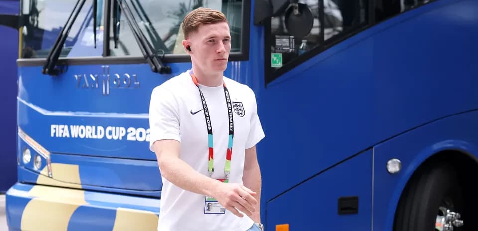 Player walking past team bus at World Cup