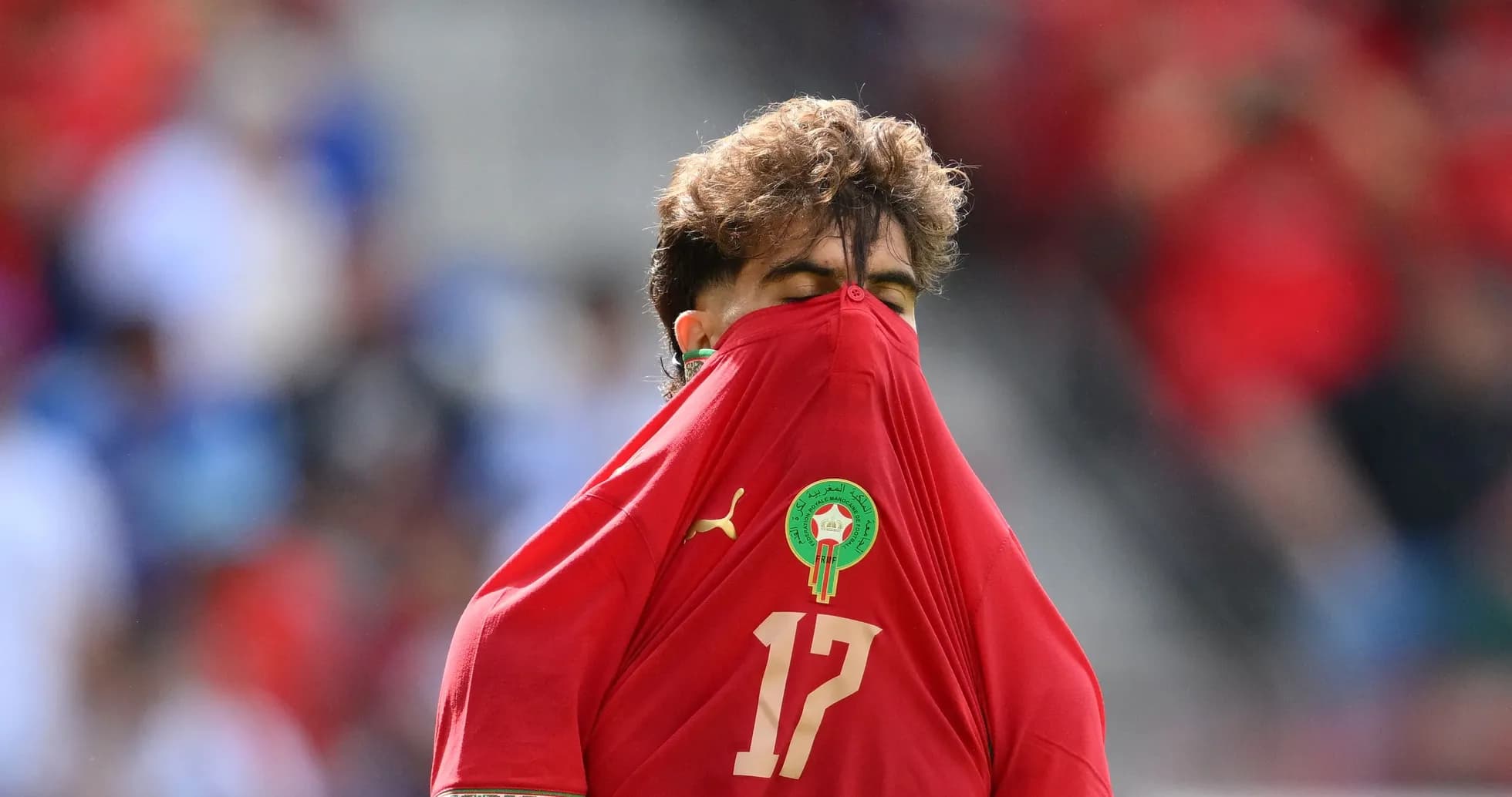 Player pulling jersey over face during match