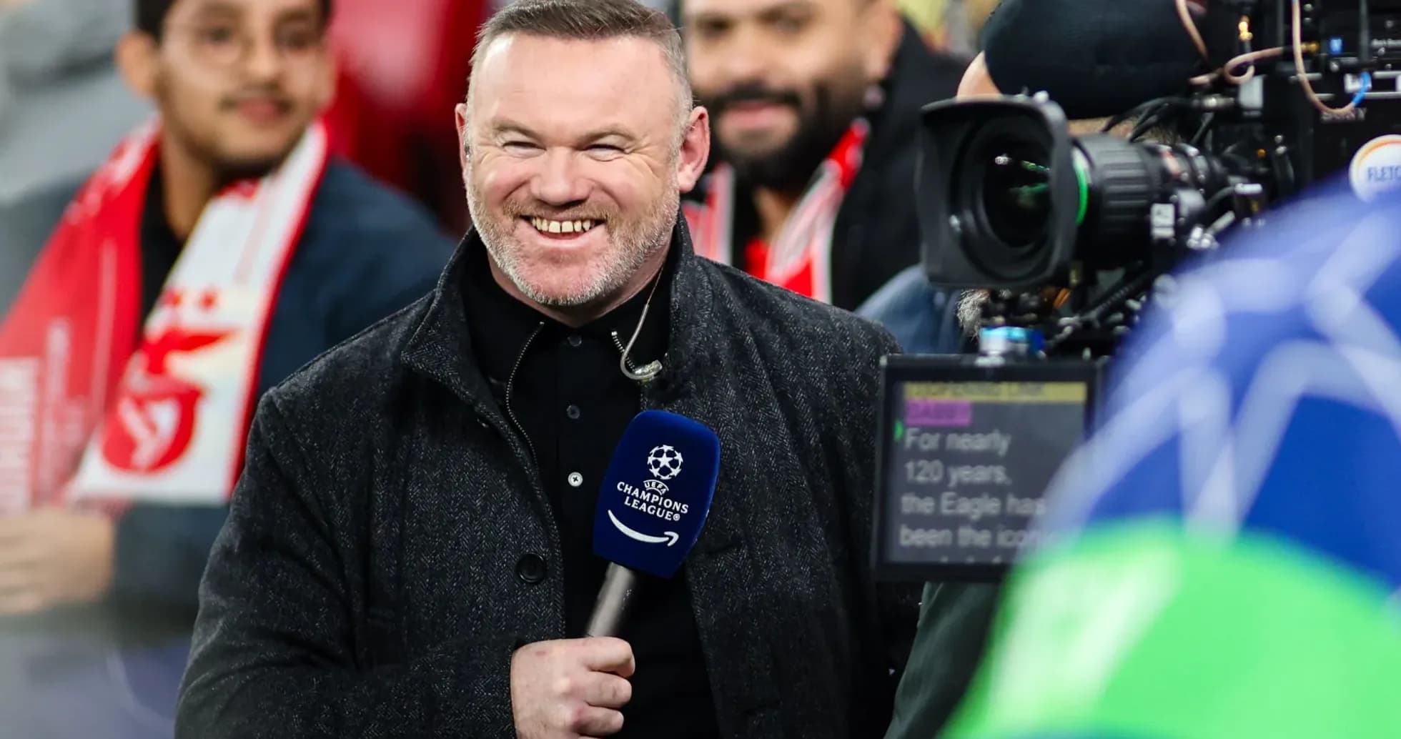 Presenter smiling during UEFA Champions League coverage