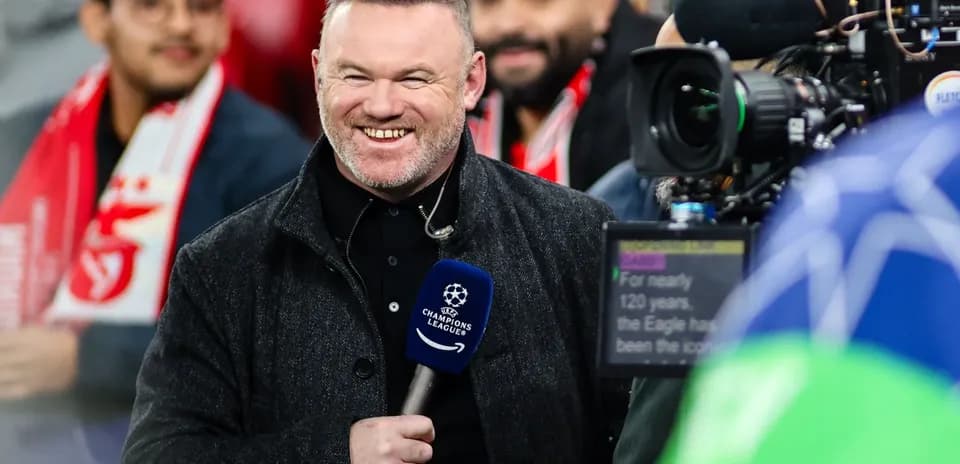 Presenter smiling during UEFA Champions League coverage