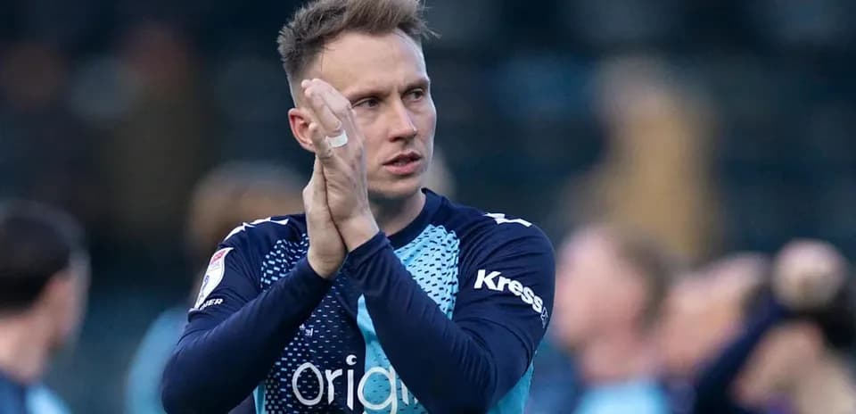 Goalkeeper applauding fans after the match