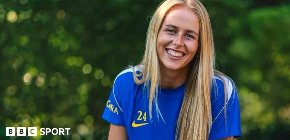 Female football player smiling in training kit
