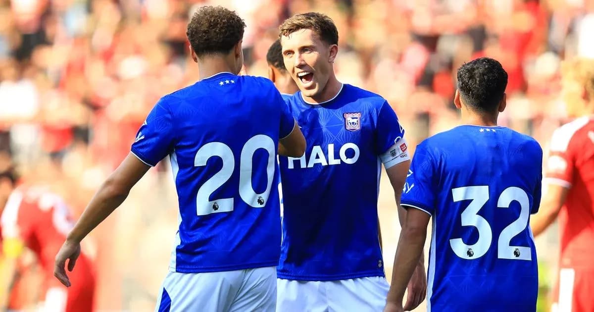 Three players celebrating in blue team jerseys