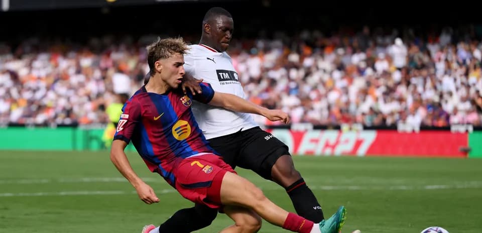 Player from Barcelona tackling opponent during match