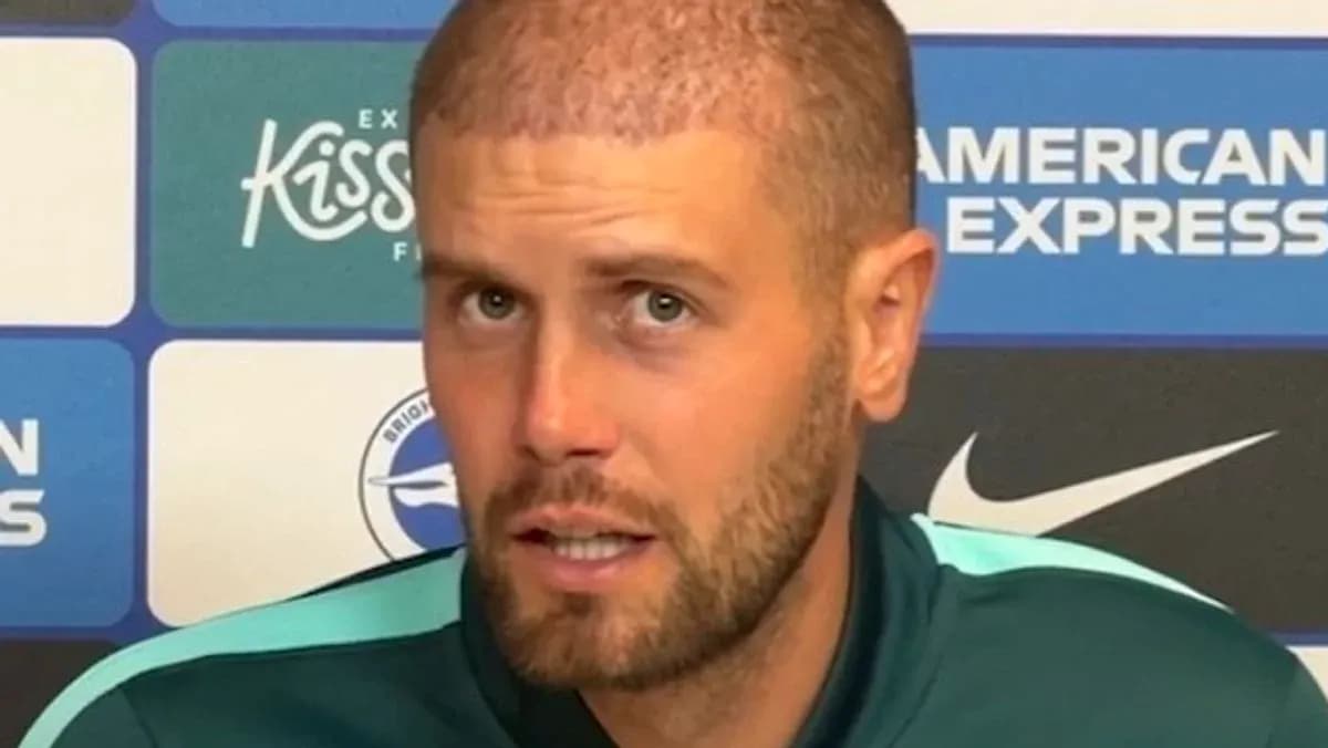 Athlete speaking at press conference with branding backdrop