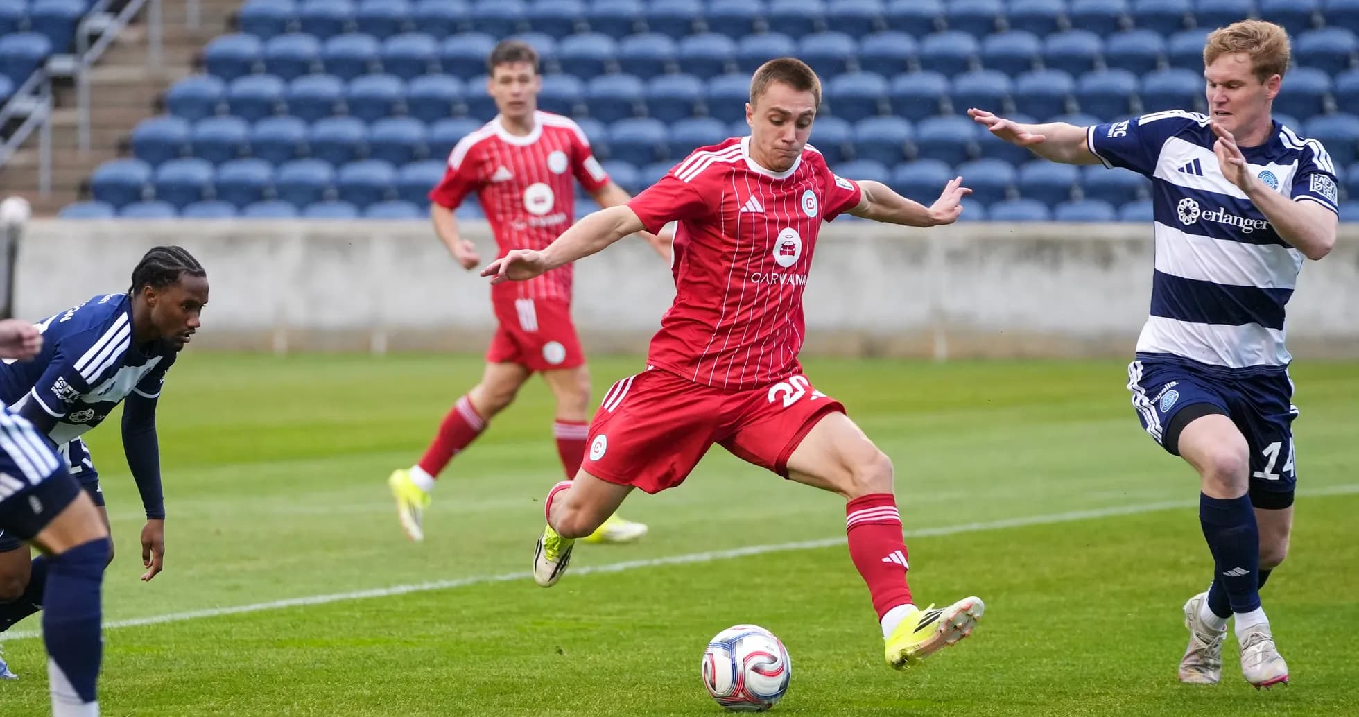 Players competing for the ball in MLS Next Pro