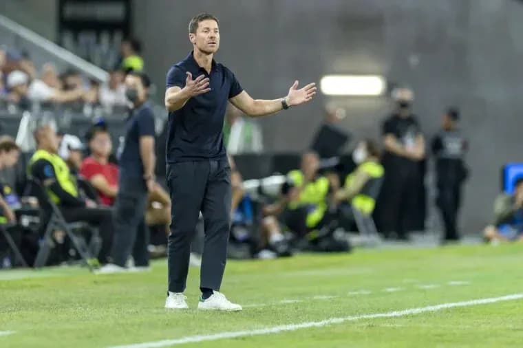 Coach gesturing from the sidelines during match