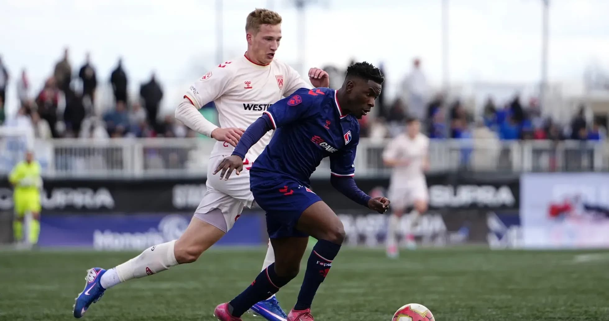 Cavalry FC player dribbling during match