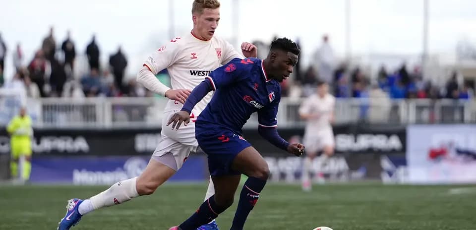 Cavalry FC player dribbling during match
