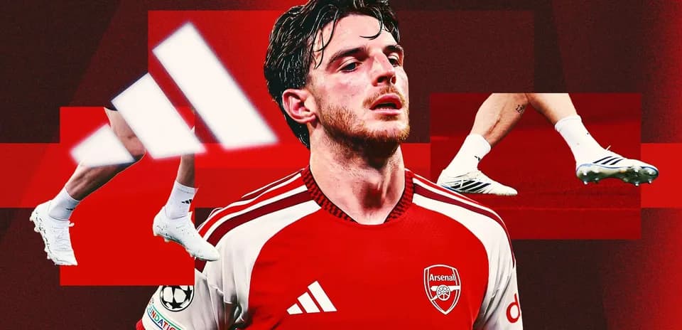 Arsenal player wearing red jersey and white boots