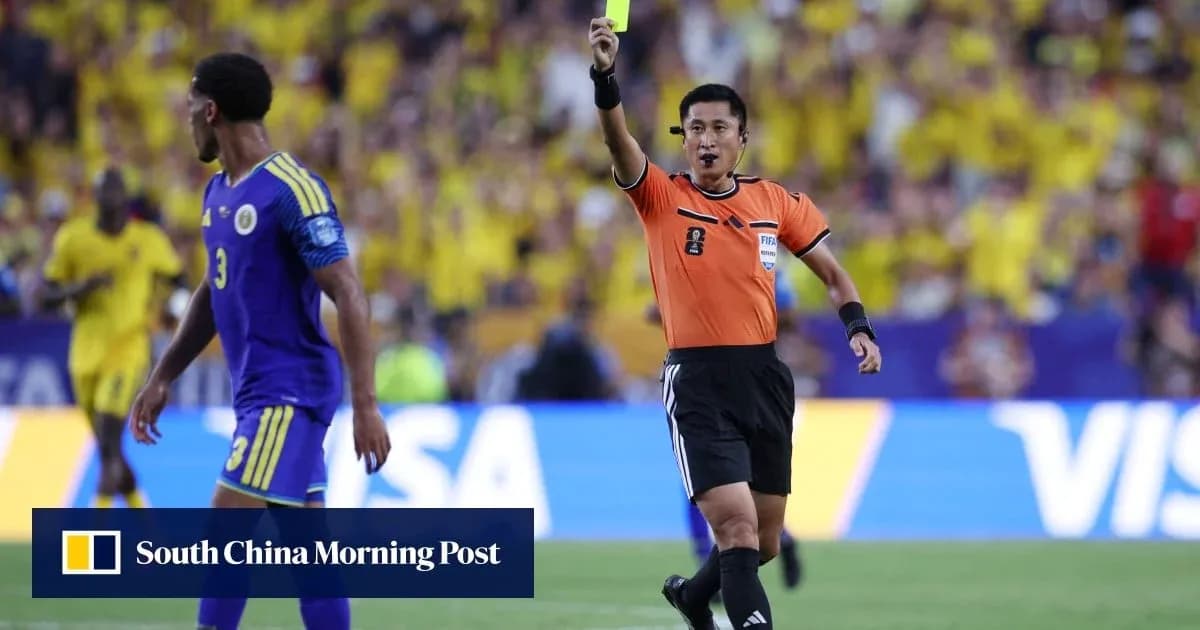 Referee showing yellow card to player during match