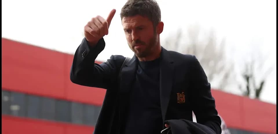 Man giving a thumbs-up outside stadium entrance