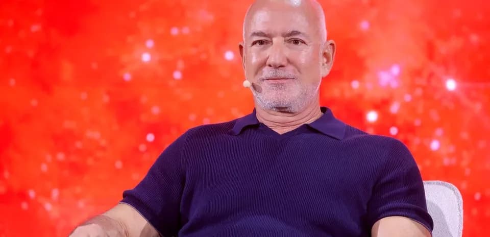 Man sitting on stage with red background