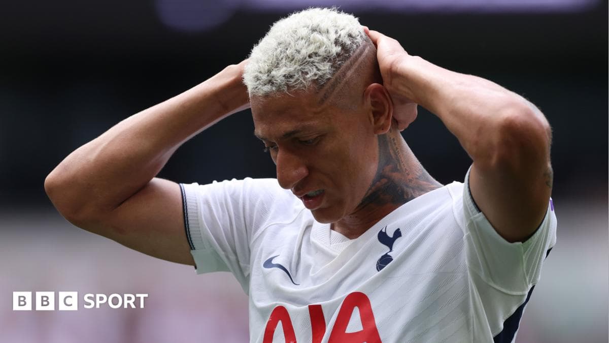 Player holding head in distress on the pitch