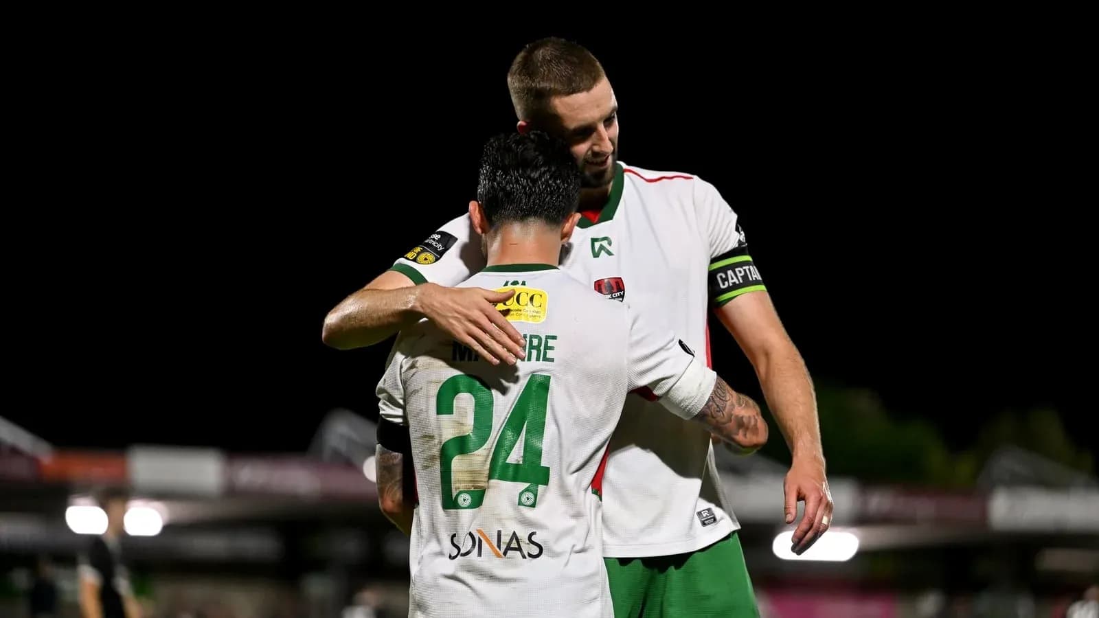 Two players embracing on the field after match