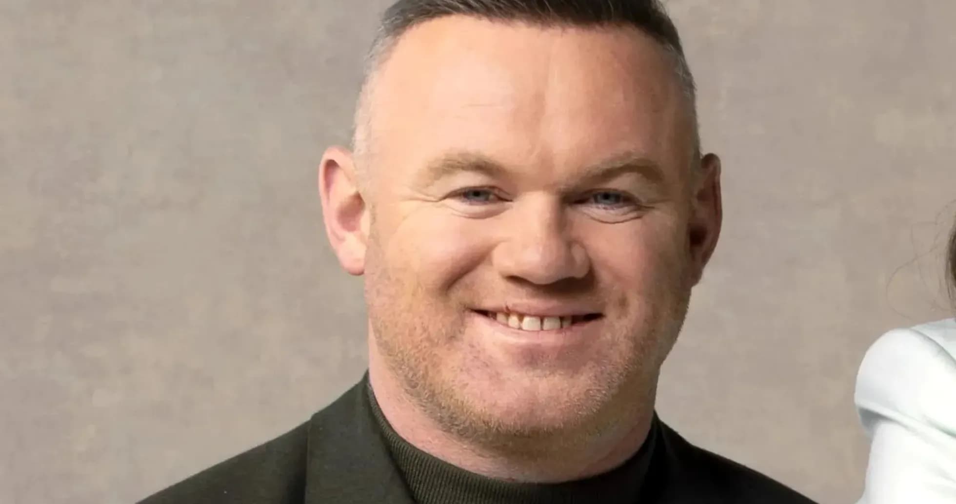 Man smiling against a neutral background