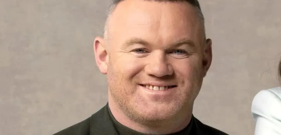 Man smiling against a neutral background