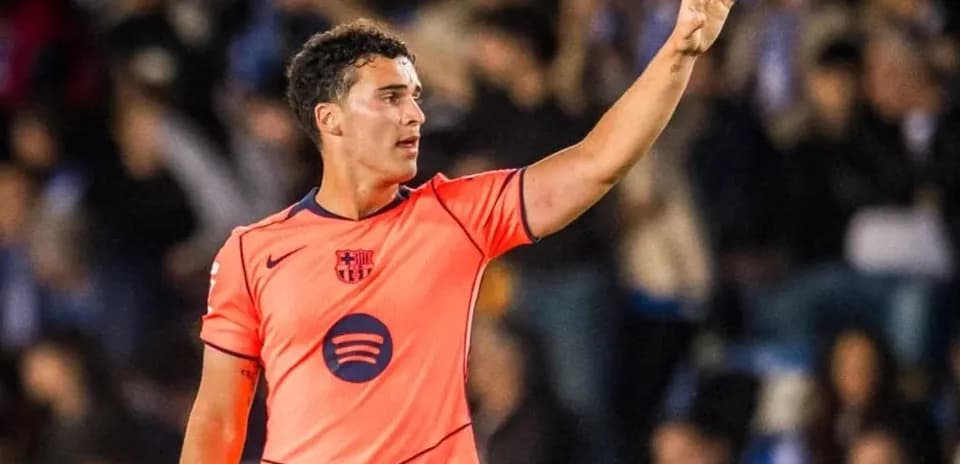 Player in orange jersey gesturing on the field