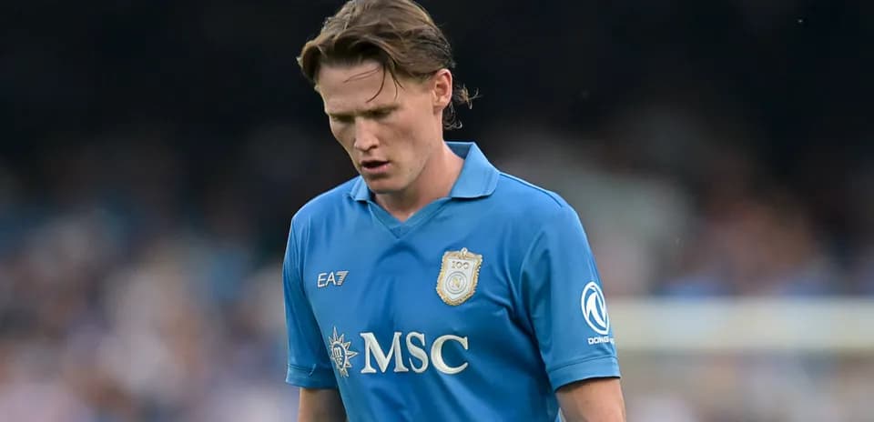 Player in blue jersey walking on the pitch