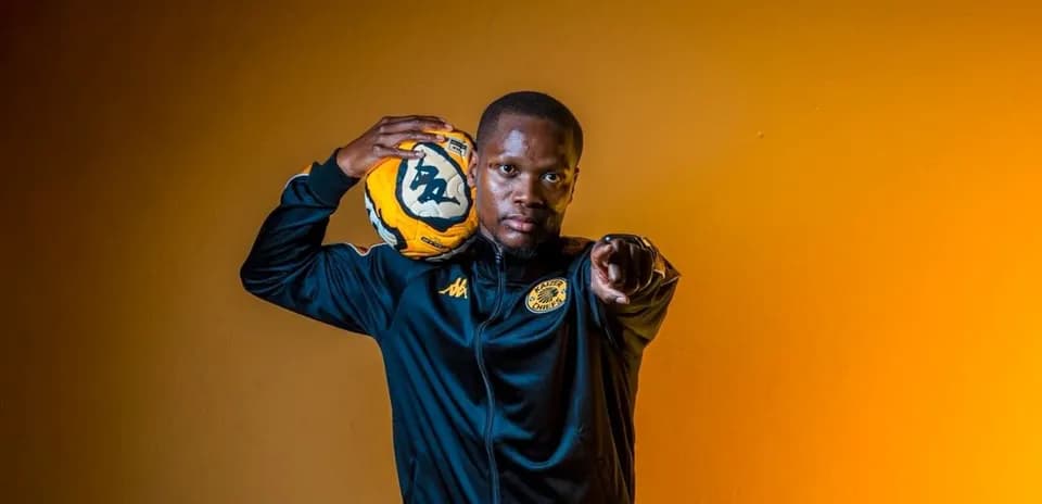 Player holding a soccer ball and pointing