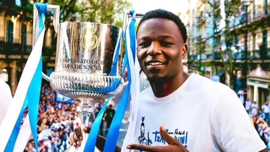 Player celebrating with trophy during victory parade Player celebrating with trophy during victory parade