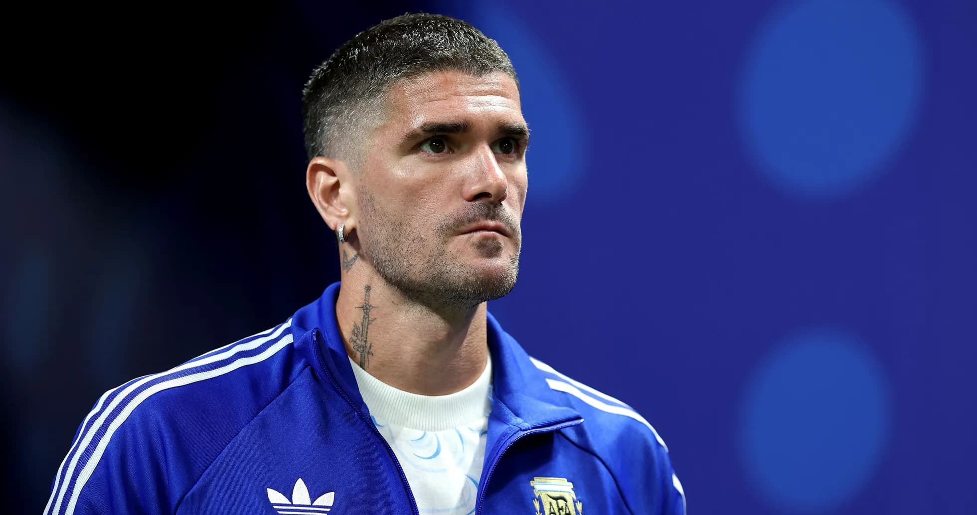 Player in blue jacket during a press event