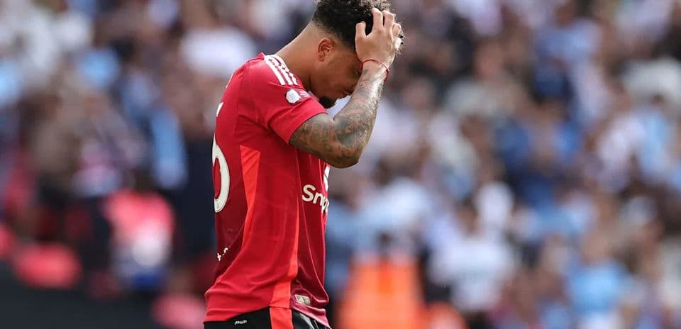 Player in red jersey holding head in disappointment