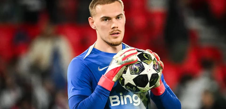 Goalkeeper holding a football before the match
