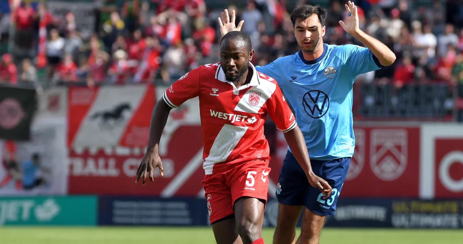 Players competing in HFX Wanderers vs Cavalry match