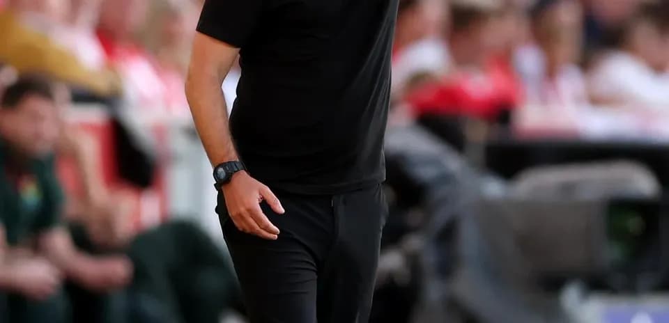 Coach directing players from the sidelines during match