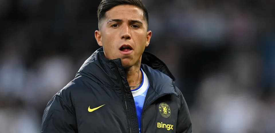 Player in Chelsea jacket on sidelines during match