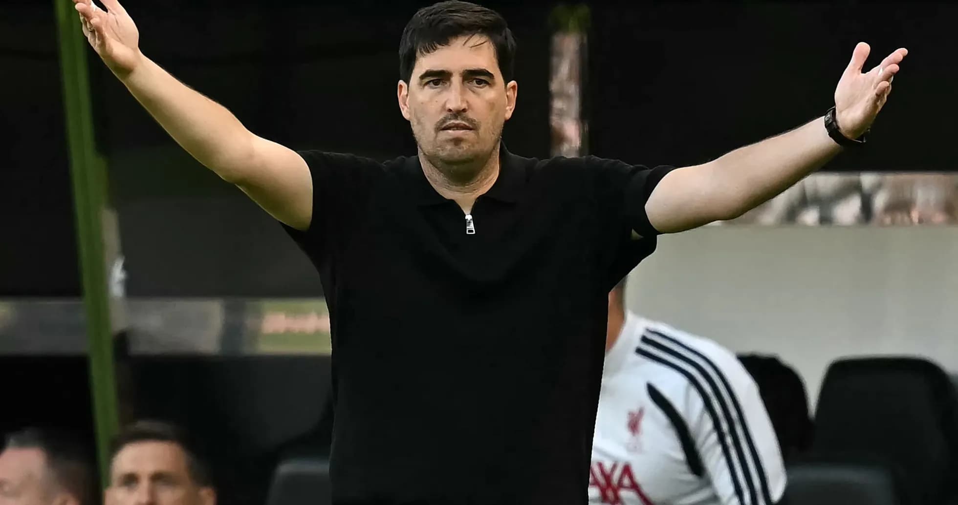 Coach gesturing from the sidelines during match