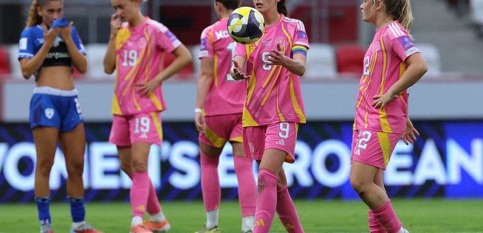 Players in pink uniforms during a women's football match
